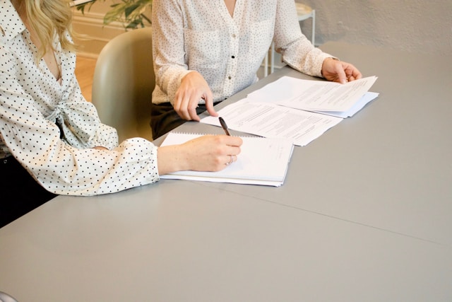 people signing the documents required to study in Italy